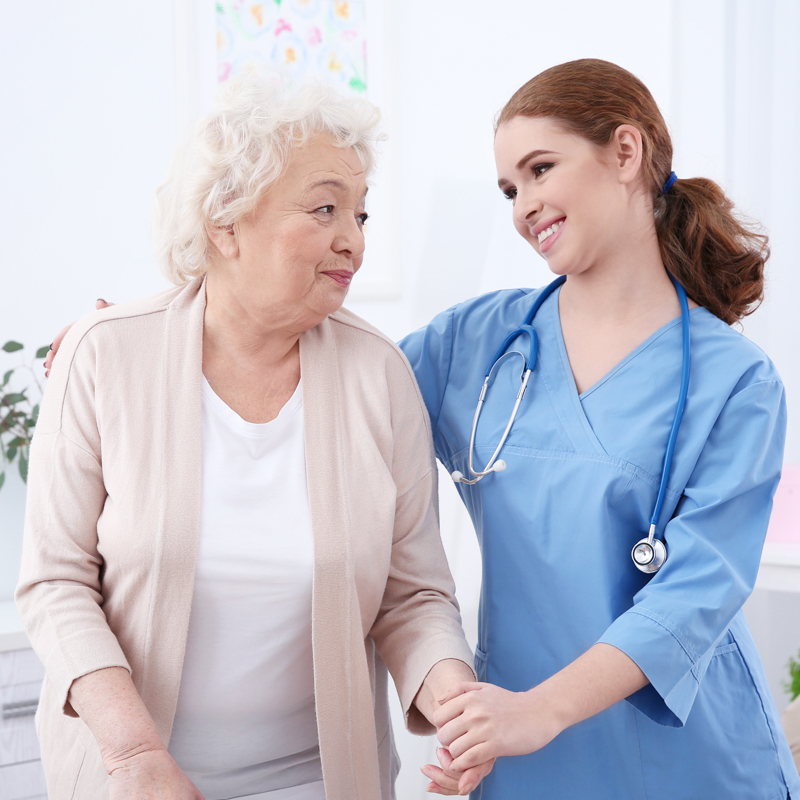 nurse holding an elderly woman 