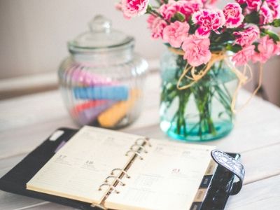 Diary on table with flowers