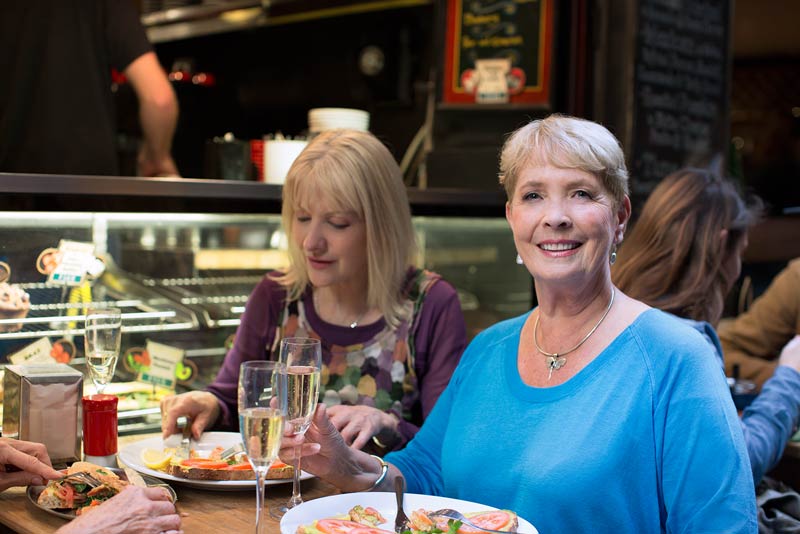 Lady with hearing problems having lunch with friends