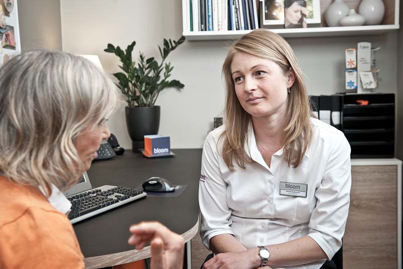 Hearing aids consultant helping hearing loss patient