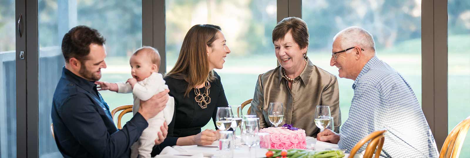 Parents and grandparents with kid having lunch